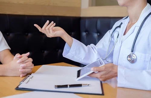 доктор описывает пациенту план лечения раздражительности